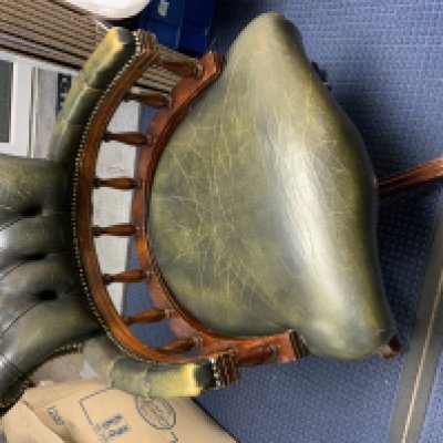 A leather upholstered revolving captains chair.