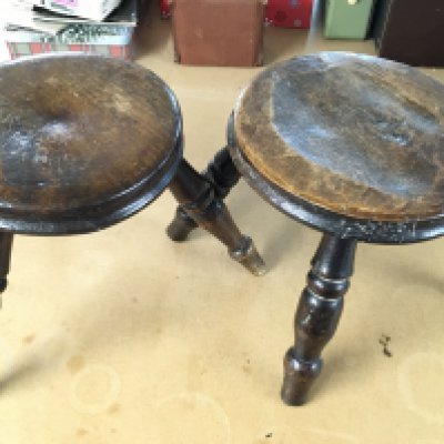 A three legged milking stool 8.5" tall and a four legged milking stool 7.5" tall. Postage C
