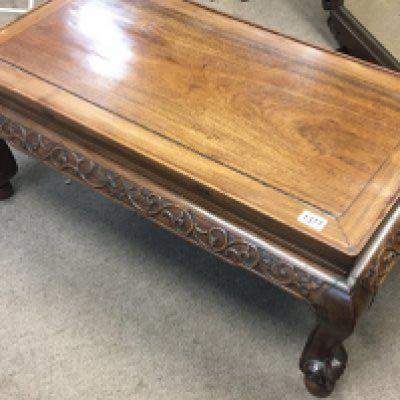 A 20th century Chinese carved hardwood rectangular coffee table with shaped legs.