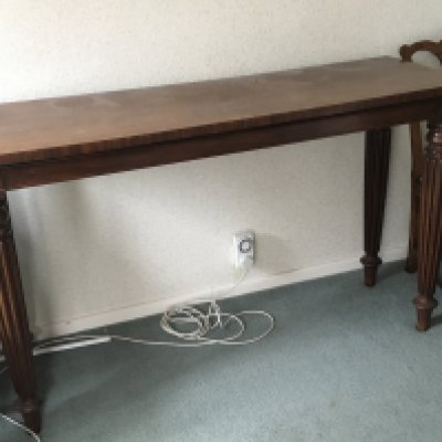 An Early Victorian Mahogany serving table the rectangular top on turned and tapering reeded legs length 153cm.