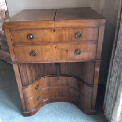 A George III mahogany traveling dressing chest with a hinged top above a well fitted interior and drawers with a sliding tambour inverted cupboard.