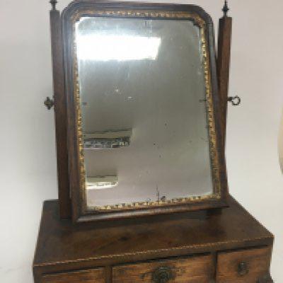 A George III mahogany dressing table mirror with three drawers.