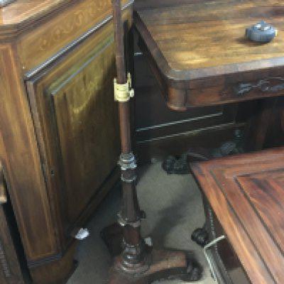 A William IV Rosewood pole screen with an elaborate support and scroll feet.