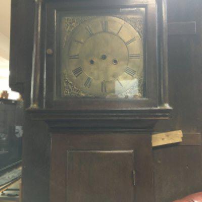 A oak long case clock the brass dial with Roman numerals. NO RESERVE
