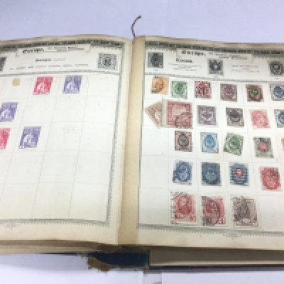 An interesting Empire Postage stamp album containing early Victorian circa 1840s onwards used world stamps. The album includes a rare Russian 1902 5k red violet stamp, a rare early Victorian Leeward Island stamp with cut edges and many others. Shipping category B.