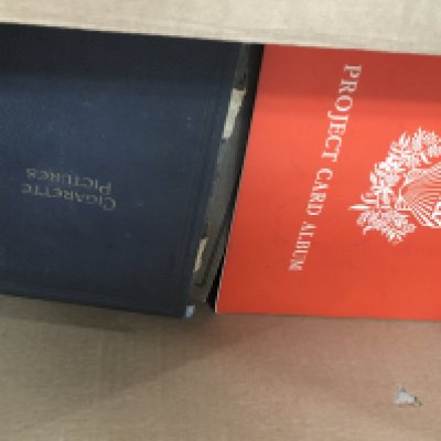 A box containing a large quantity of cigarette and tea card albums.