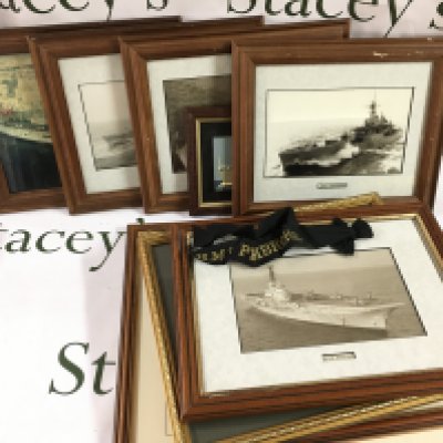 A Collection of framed photos including battle ships and a collection of cap tallys