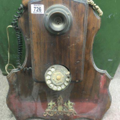 A wall mounted telephone with applied mounts . NO RESERVE