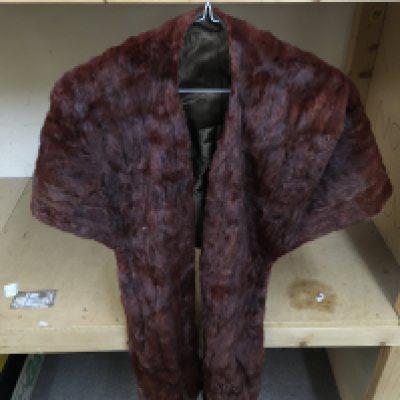 A collection of fur coats and scarfs.