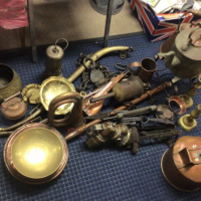 A good collection of antique metal ware copper and brass including miners lamp car lamp gin traps horse harness copper pots brass candle sticks thermometers and other items NO RESERVE