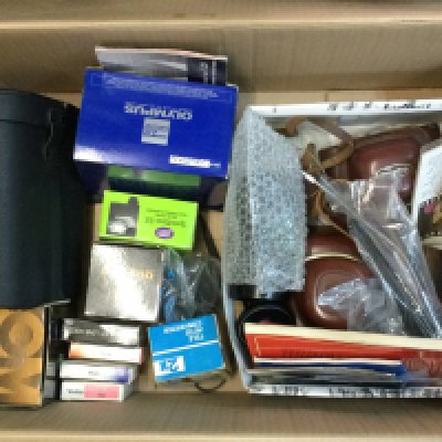 A collection of various camera equipment including an Exakta Vader 11a, Voigtlander Vito CL, Chinon 7x50 binoculars , Olympus OM10 etc
