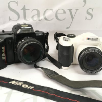 A Nikon F-401 camera and a Polaroid digital camera . Postage category B