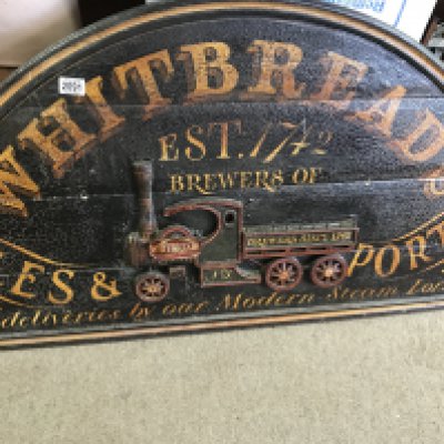 A wooden advertising sign Whitbreads all deliveries by our modern steam Lorries .