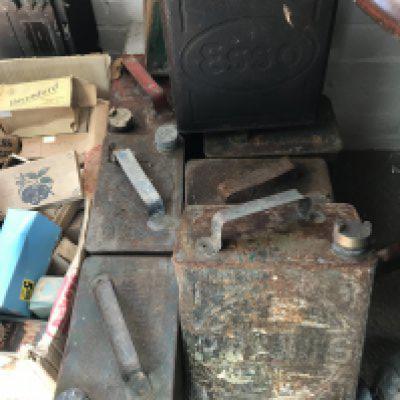 A collection of nine oil cans .