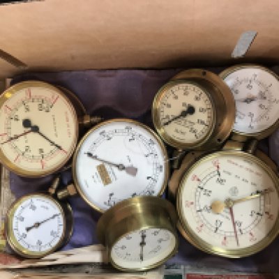 A box containing various pressure gauges.