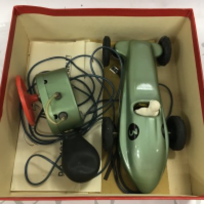A vintage phantom II motor matic car in box with other playworn cars.