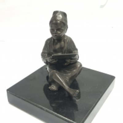 A bronze figure of an eastern boy on a marble plinth , 10cm tall. Postage cat B