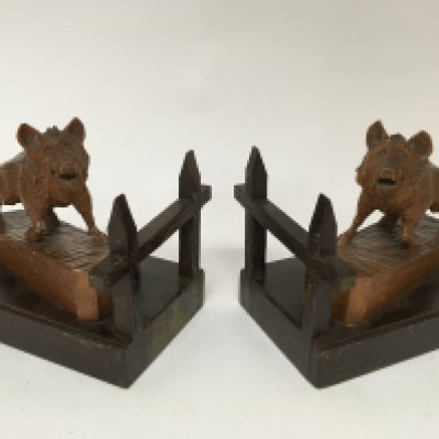 A pair of carved wood Black Forest bookends in the form of wild boar on gate post bases length 24cm