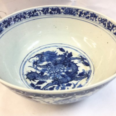 A late 19th century Chinese porcelain blue and white dragon bowl , 30cm wide 12cm tall. Flaws in the glaze. This lot cannot be posted