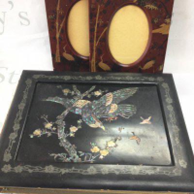 A Japanese lacquered album with silk paintings and a pair of Japanese oval photo frames with heron and bamboo decoration. Postage category C