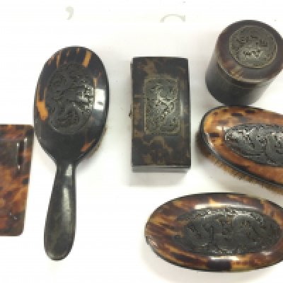 Tortoiseshell dressing table set including brushes, containers and a tray . postage category B
