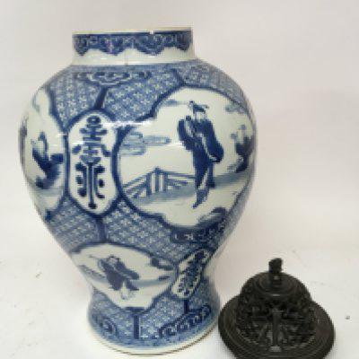 A Chinese Export porcelain blue and white 19th century vase decorated with panels of figures and of bulbs shape sold with a carved hardwood cover hairline crack hight 35cm.