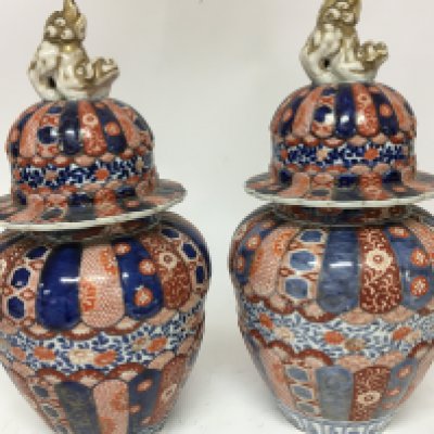 A pair of Japanese Imari late 19th century vases with covers surmounted with dogs of foo. Some restoration height 42cm
