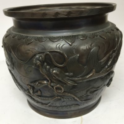 A Japanese late 19th century bronze jardiniere decorated with raised dragons signed base . diameter 26cm diameter.