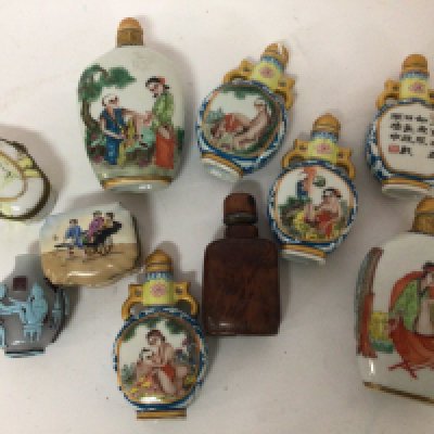 A collection of Oriental porcelain scent bottles with Kama Sutra scenes and other porcelain boxes and scent bottles.
