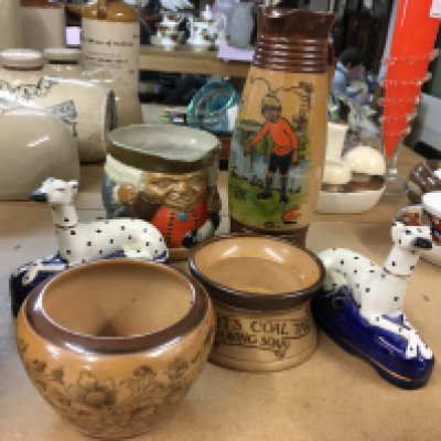 A collection of Doulton Stoneware including Toby Jug, shaving bowl, one other bowl and jug and a pair of Staffordshire dogs
