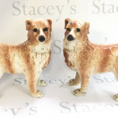 A pair of ceramic Staffordshire dog figures with glass eyes. 28.5cm tall. Some damage This lot cannot be posted