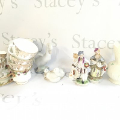 A collection of ceramics including a Royal Doulton Sit figure, Nao swans and a large collection of plates including Paragon Brides Choice. This lot cannot be posted