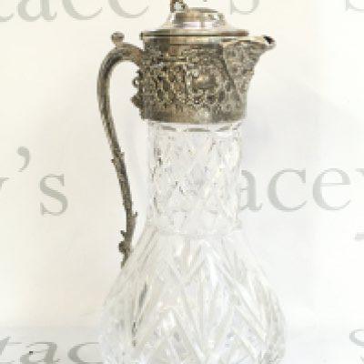 A cut glass jug with a lion and shield figure topper , 32cm tall. No obvious large damage or restoration This lot cannot be posted