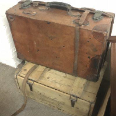 A Gordons london dry gin crate and a vintage leather suitcase