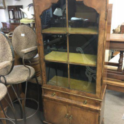 A Walnut bookcase with a glazed door above drawer and cupboards. NO RESERVE