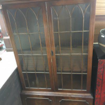 A mahogany bookcase with glazed doors above cupboards, dimensions 185x90x34cm