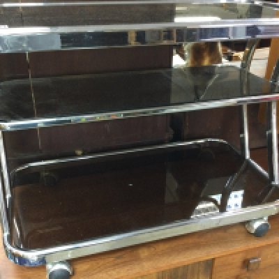 A three tier chrome trolley inset with glass tops on casters . 83cm x 44 cm . NO RESERVE