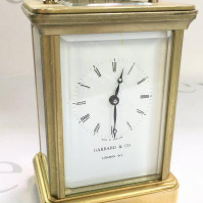 A brass Garrard & Co carriage clock, dimensions 6x8x12cm approximately. With key , seen working. this lot cannot be posted