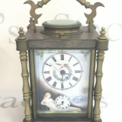 A mid 20th century carriage clock with porcelain panels decorated with nude women. This lot cannot be posted