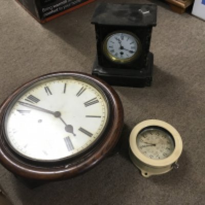 A collection of clocks including a slate mantle clock, oak wall clock and a B.C.G Lemania metal clock. This lot cannot be posted