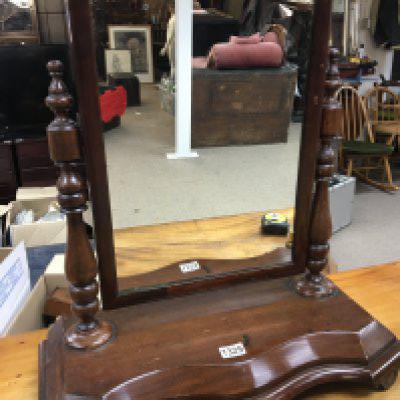 A Victorian mahogany dressing mirror with turned supports.