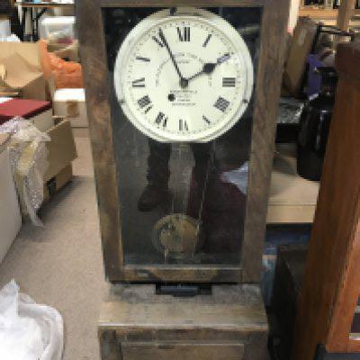 A large oak cased clocking in clock.