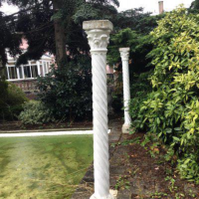 A set of eight composition garden pillars free standing stylised Corinthian columns with acanthus leave capitals and spiral coloums. Good condition not fixed to the ground so easy to collect sold in situ buyer to collect height 213cm high.