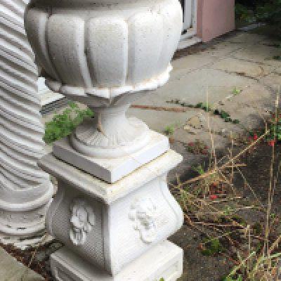 A composition garden urn and stand of classical influences with stylised acanthus leaves the base with raised lion masks good Condition and with makers stamp height 109cm sold in situ buyer to collect.