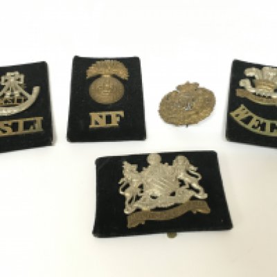 A Collection of British military cap badges including KSLI, Welsh, Northumberland Fusiliers, Manchester, Royal Engineers . Postage category A