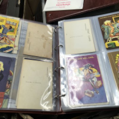 Four boxes containing a large quantity of postcards including an album of Vintage comical cards British Philatelic bureau cards and many others.