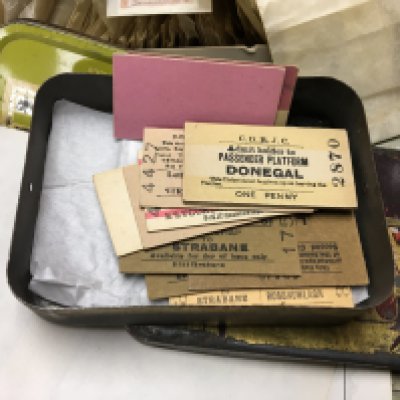A box containing mixed stamps including Victorian and later world stamps also tins containing vintage train tickets.