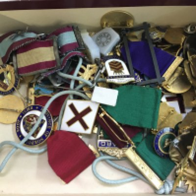 A box of vintage badges and medals including masonic and club badges. Postage category a