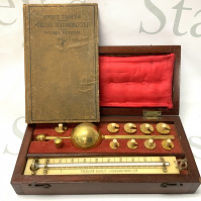 A cased Sikes Hydrometer with Spirit tables pocket edition book.