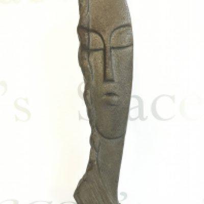 A Modigliani Style iron Head ornament, 30cm tall. postage category b